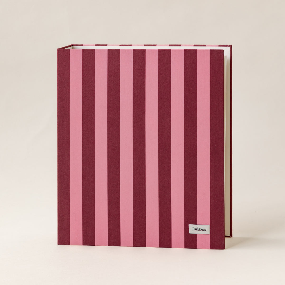 Document organizer with pink and purple vertical stripes on a beige background