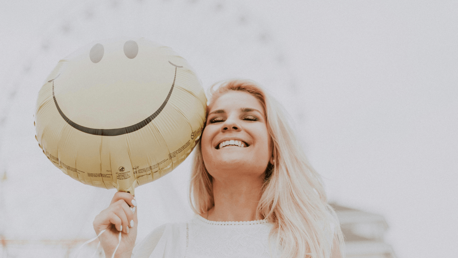 A Happy Woman With A Smiley Balloon