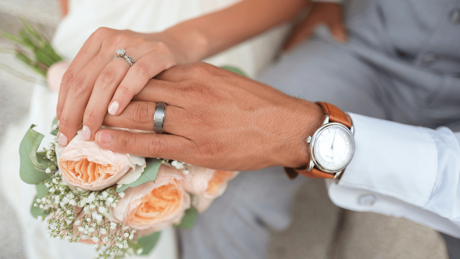 newlywed couple holding hands