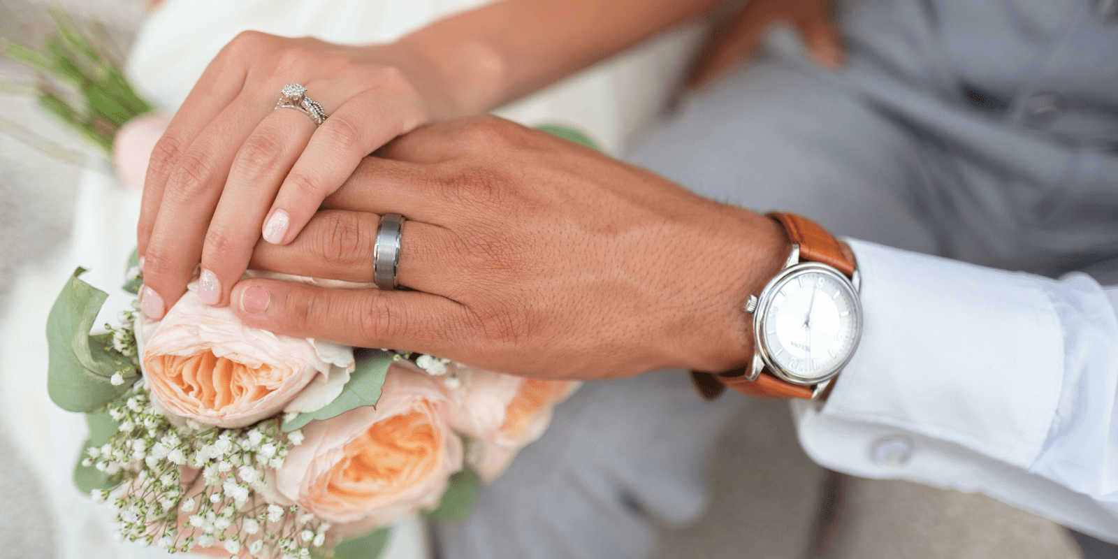 newlywed couple holding hands