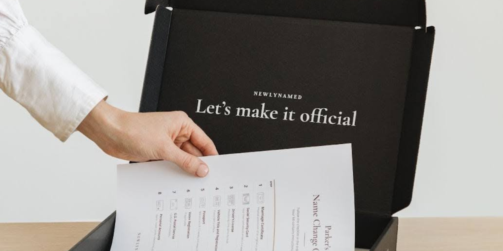 A Person Putting Papers In A NewlyNamed Box