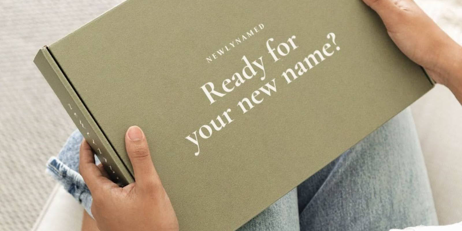 A woman holding a newlynamed box before starting her name change