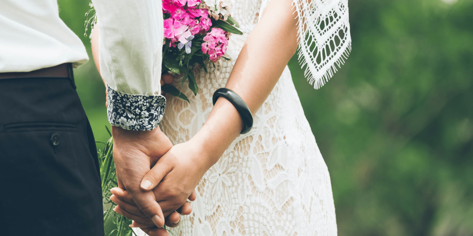 Couple Holding Hands At Their Wedding