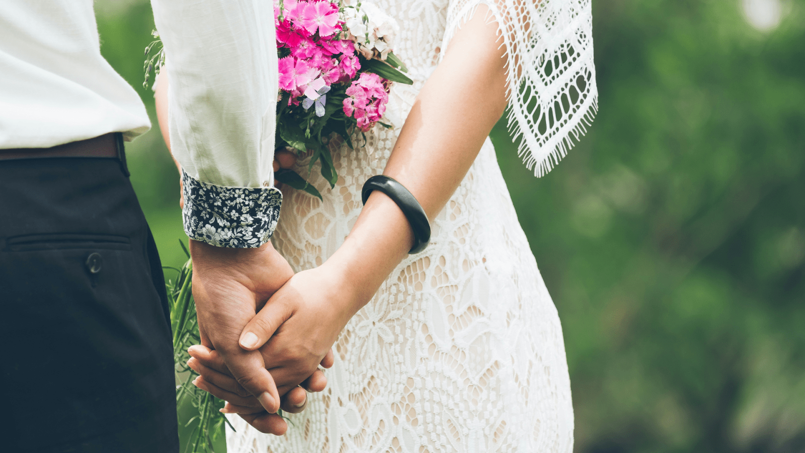 Couple Holding Hands At Their Wedding