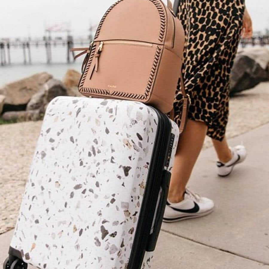Woman with luggage traveling internationally with Global Entry after marriage name change