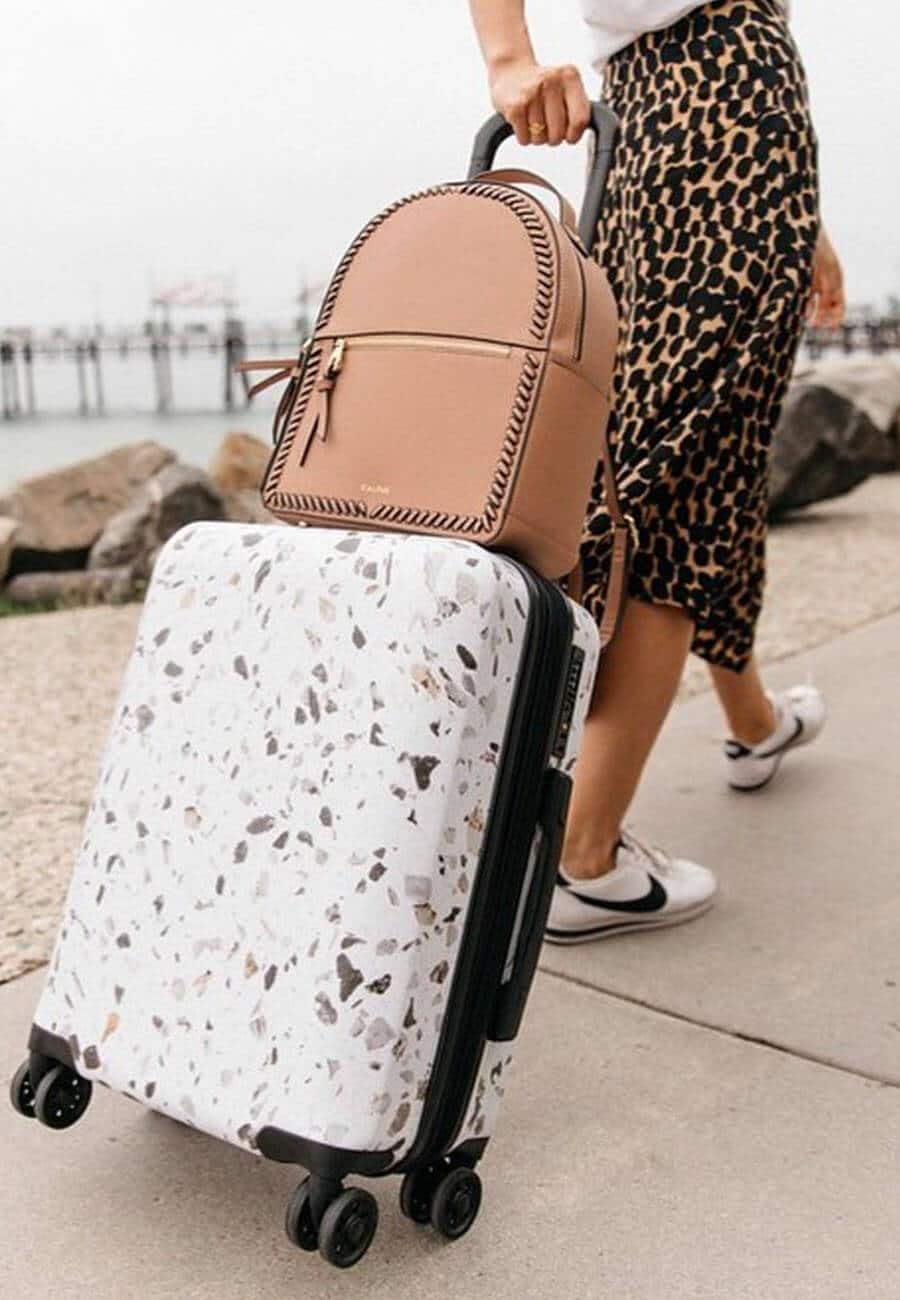 Woman with luggage traveling internationally with Global Entry after marriage name change