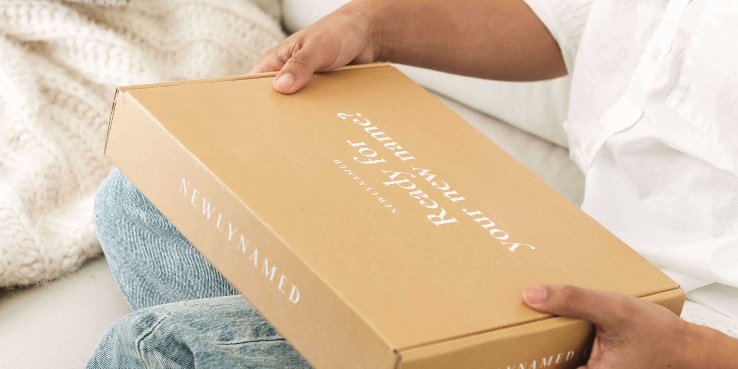 A woman holding a newlynamed box