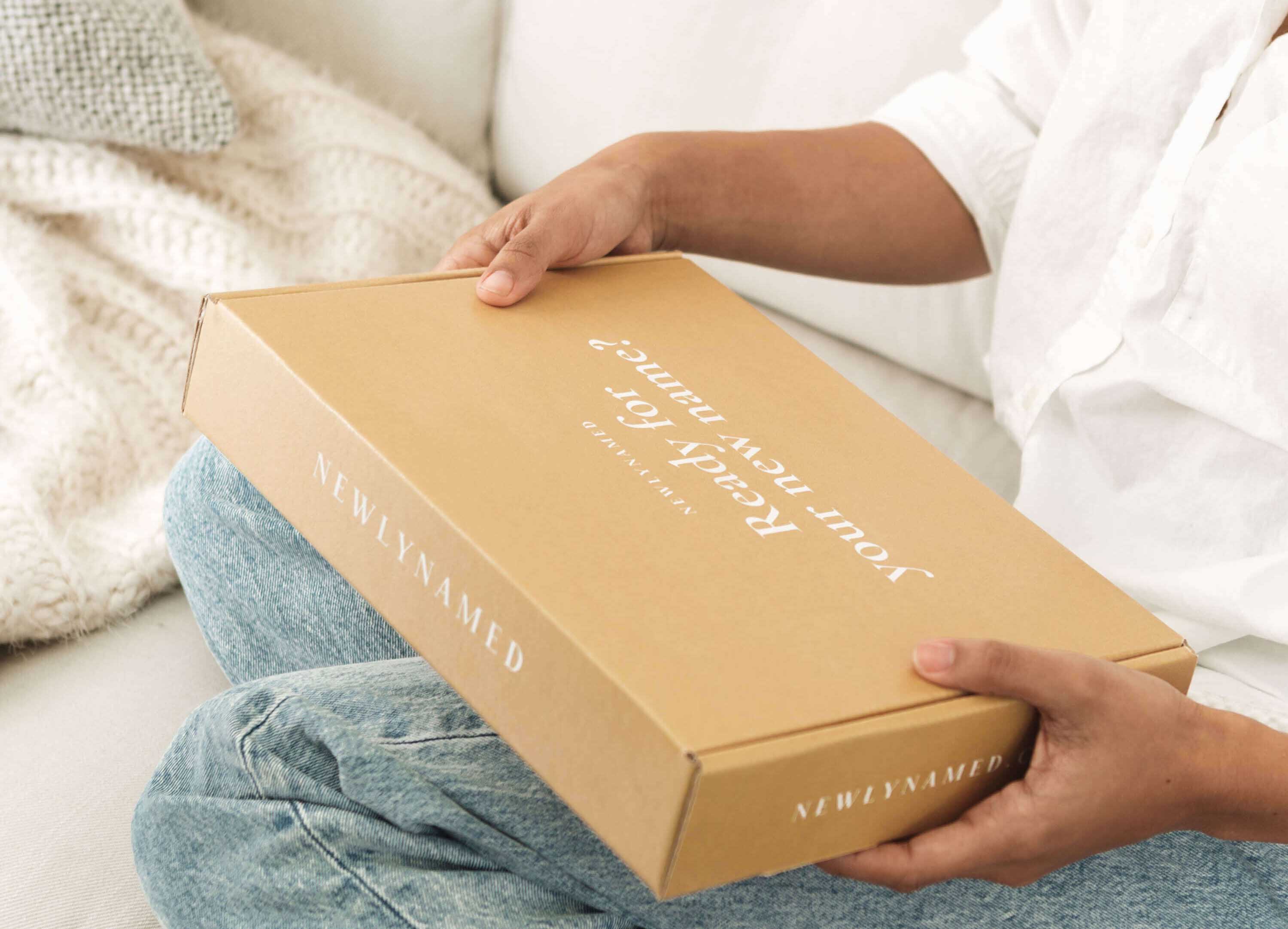 A woman holding a newlynamed box