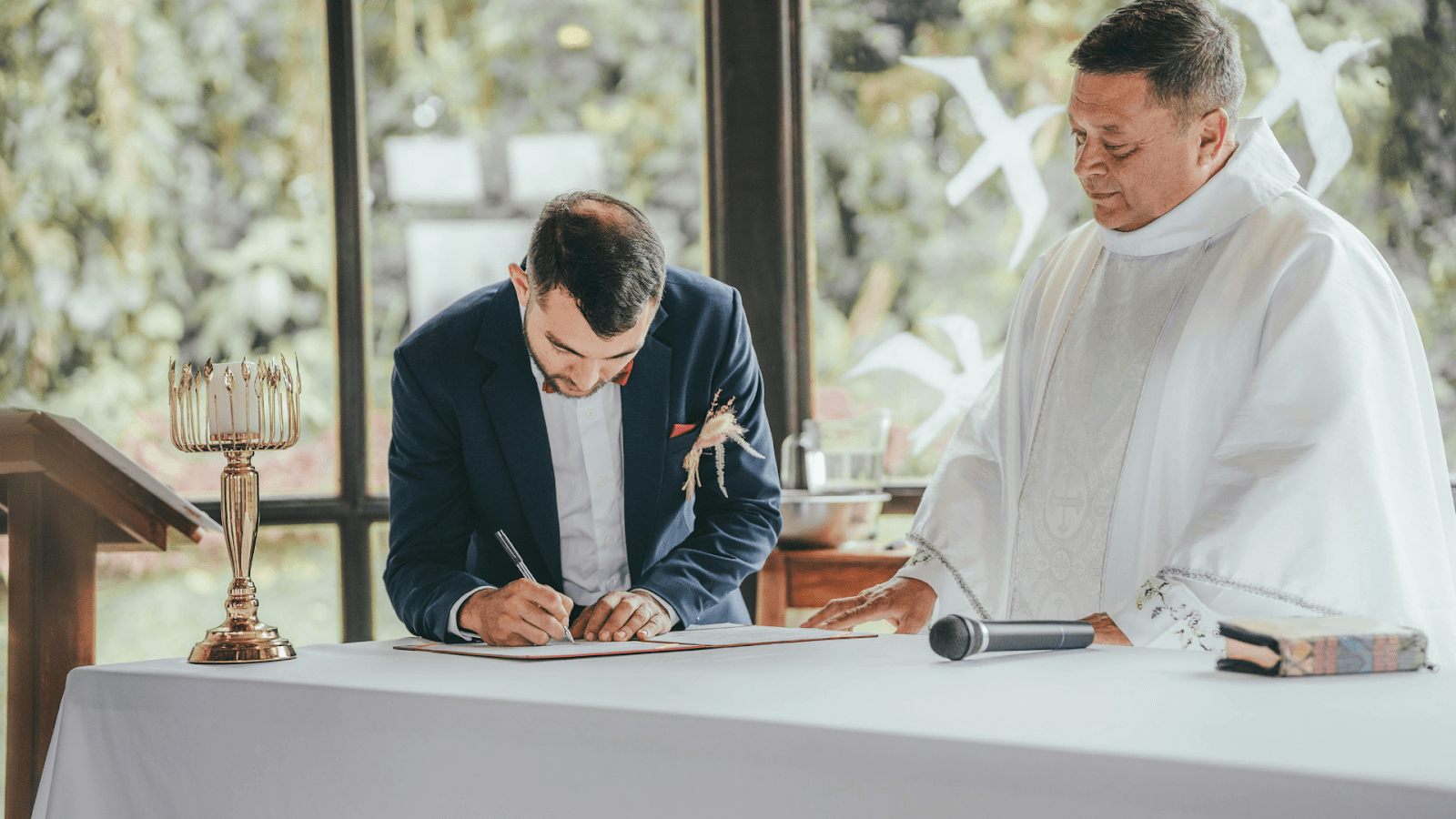 Marriage Officiant Observing Groom Signing Marriage License