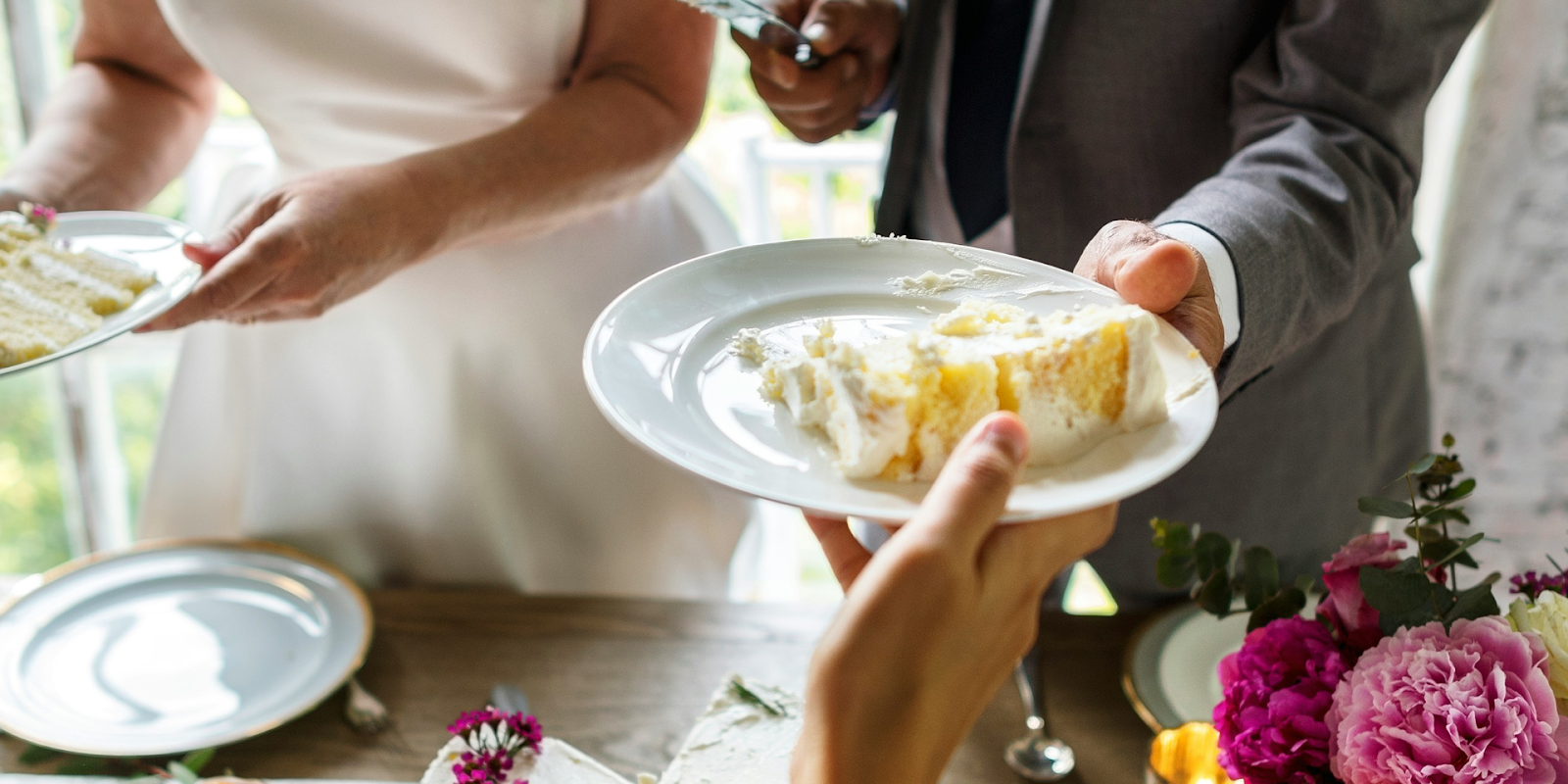 Married Couple Handing Out Wedding Cake