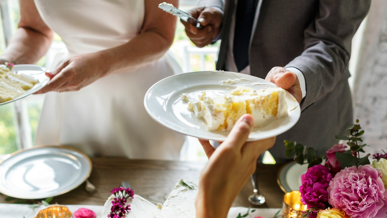 Married Couple Handing Out Wedding Cake