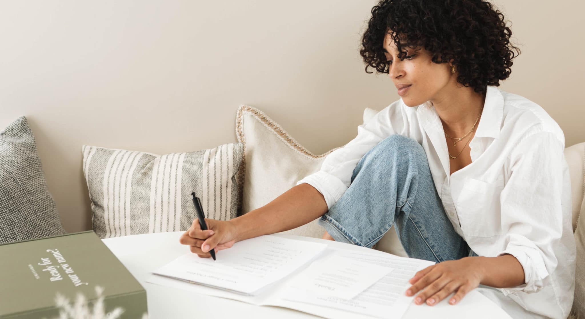 A woman at a desk with a NewlyNamed Box