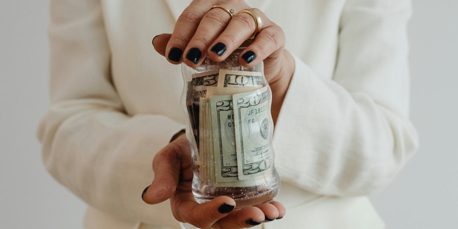 Woman Holding Jar Of Money For Her Wedding Budget