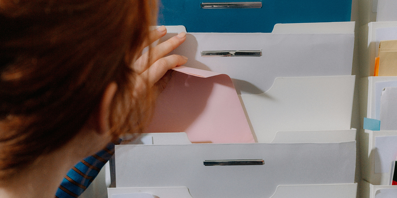 Woman Storing Important Documents Safely At Home