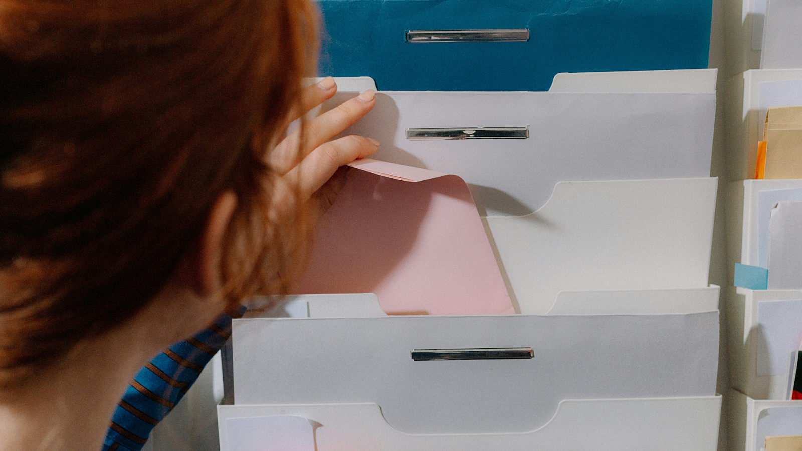 Woman Storing Important Documents Safely At Home