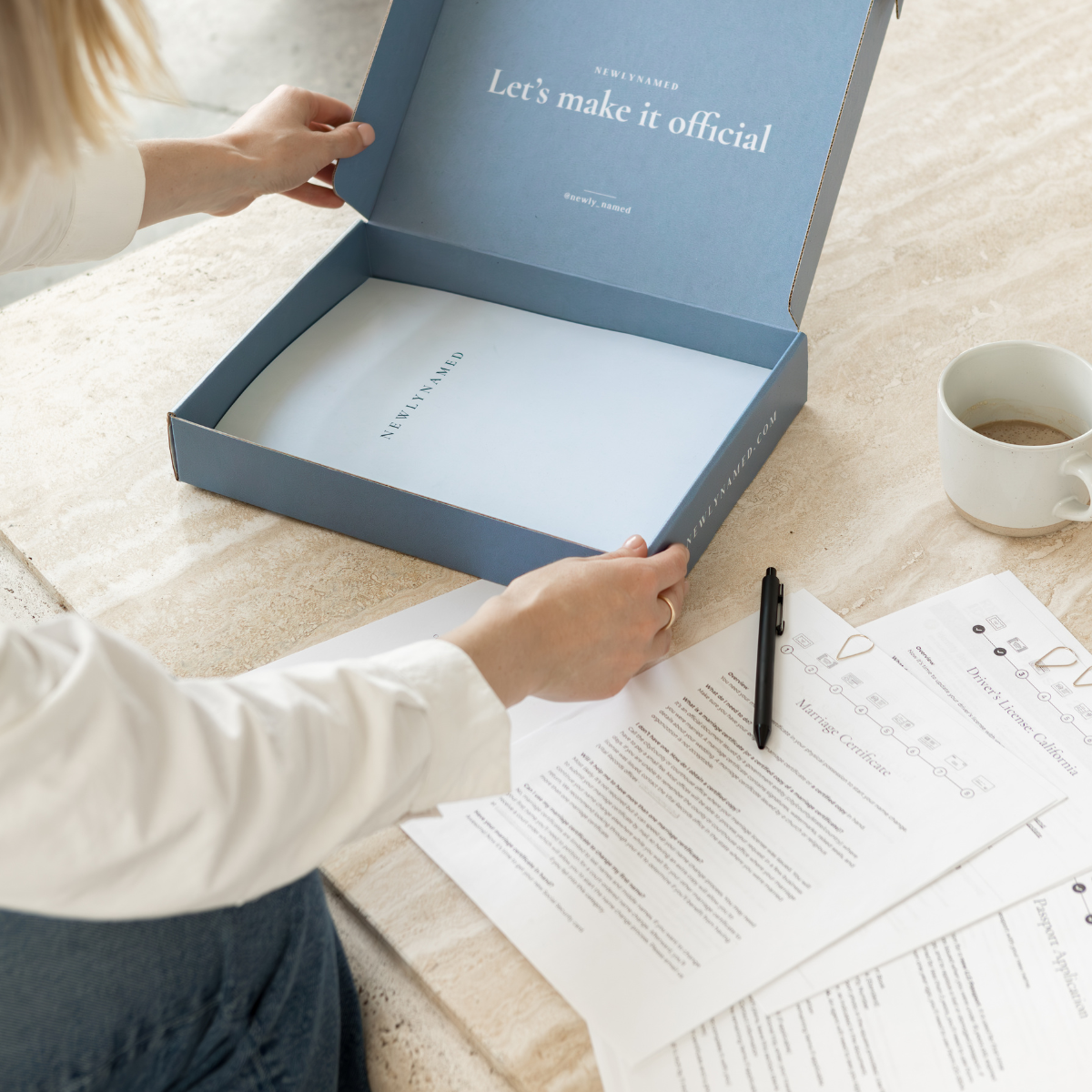 Woman opening a blue NewlyNamed box