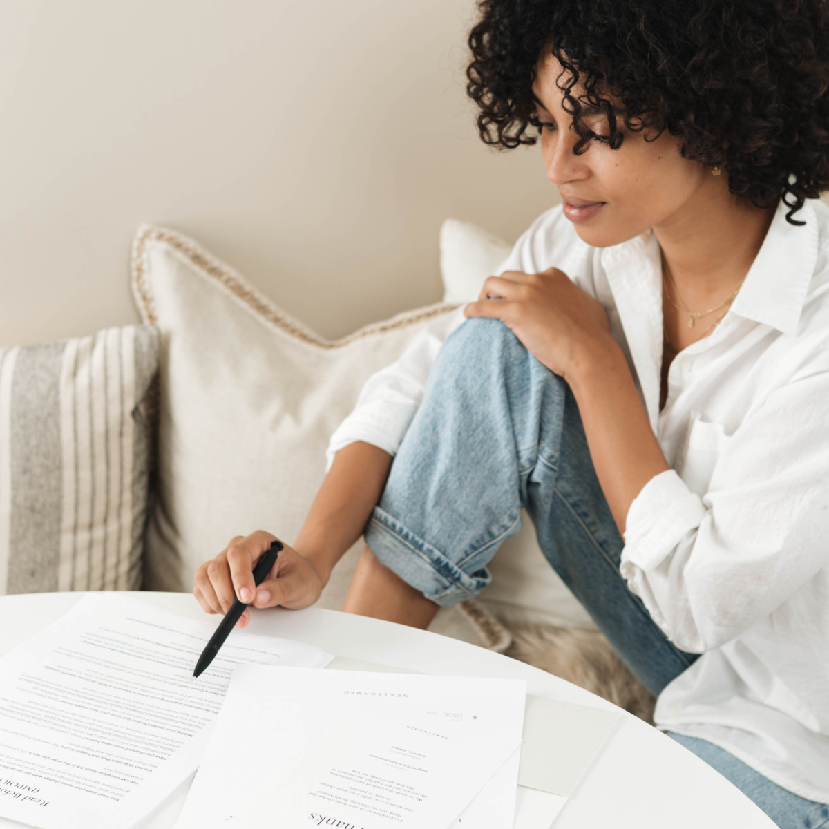 Woman with name change forms spread out on table