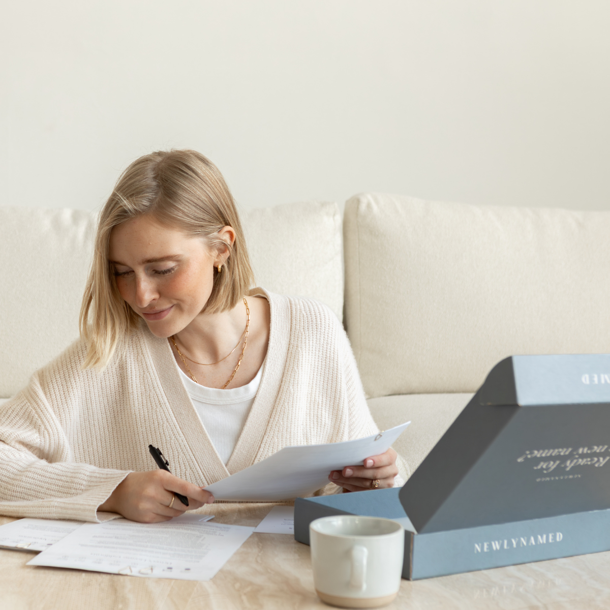 Woman filling out NewlyNamed packaged name change forms