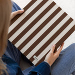 DailyDocs document organizer in Biscotti brown and cream striped design held in a lifestyle setting