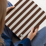 DailyDocs document organizer in Biscotti brown and cream striped design held in a lifestyle setting