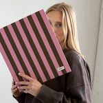 DailyDocs document organizer in Blush pink and brown striped design held in a lifestyle setting