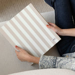 DailyDocs document organizer in Oat neutral striped design held on a sofa