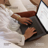 A woman using a laptop to access her NewlyNamed digital download name change kit, highlighting the personalized checklist and pre-filled accounts.