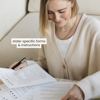 woman signing forms during the name change process