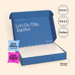 An open blue NewlyNamed Box complete marriage name change kit featuring award badges from The Knot, Brides, Vogue, and Forbes.