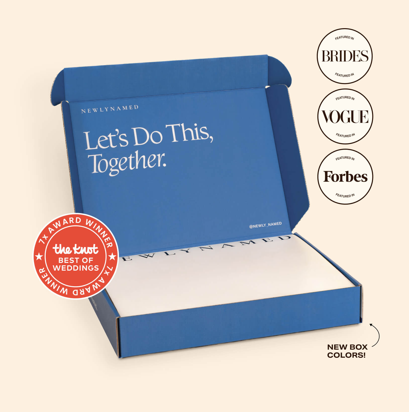 An open blue NewlyNamed Box complete marriage name change kit featuring award badges from The Knot, Brides, Vogue, and Forbes.