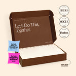 An open brown NewlyNamed Box name change kit featuring The Knot Best of Weddings award badge and a personalized marriage name change checklist inside.