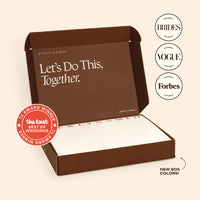 An open brown NewlyNamed Box name change kit featuring The Knot Best of Weddings award badge and a personalized marriage name change checklist inside.