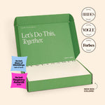 An open green NewlyNamed Box marriage name change kit showcasing features in Brides, Vogue, and Forbes magazines.