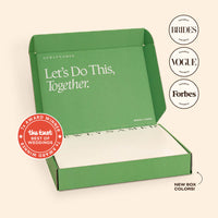 An open green NewlyNamed Box marriage name change kit showcasing features in Brides, Vogue, and Forbes magazines.