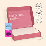 An open signature pink NewlyNamed Box personalized name change kit for post-marriage document updates.