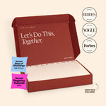 An open deep red NewlyNamed Box premium name change service kit with the inner lid reading Let's Do This, Together.